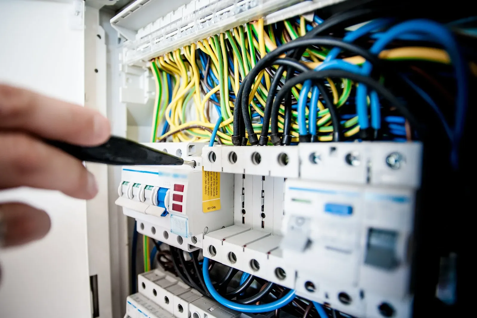 Electrician working on an opened switchboard (stock photo)